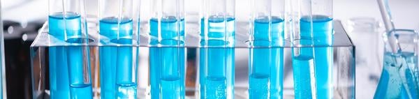 Beakers in lab aqua liquid, source: pexels.com